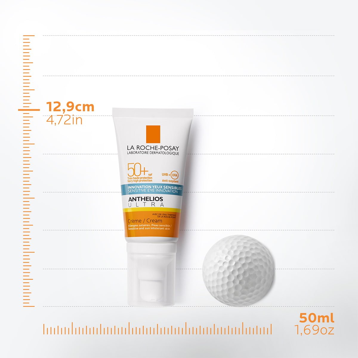Confezione Anthelios ultra face cream SPF50+ da 50ml con pallina da golf accanto su assi cartesiani che indicano 12,9cm di altezza